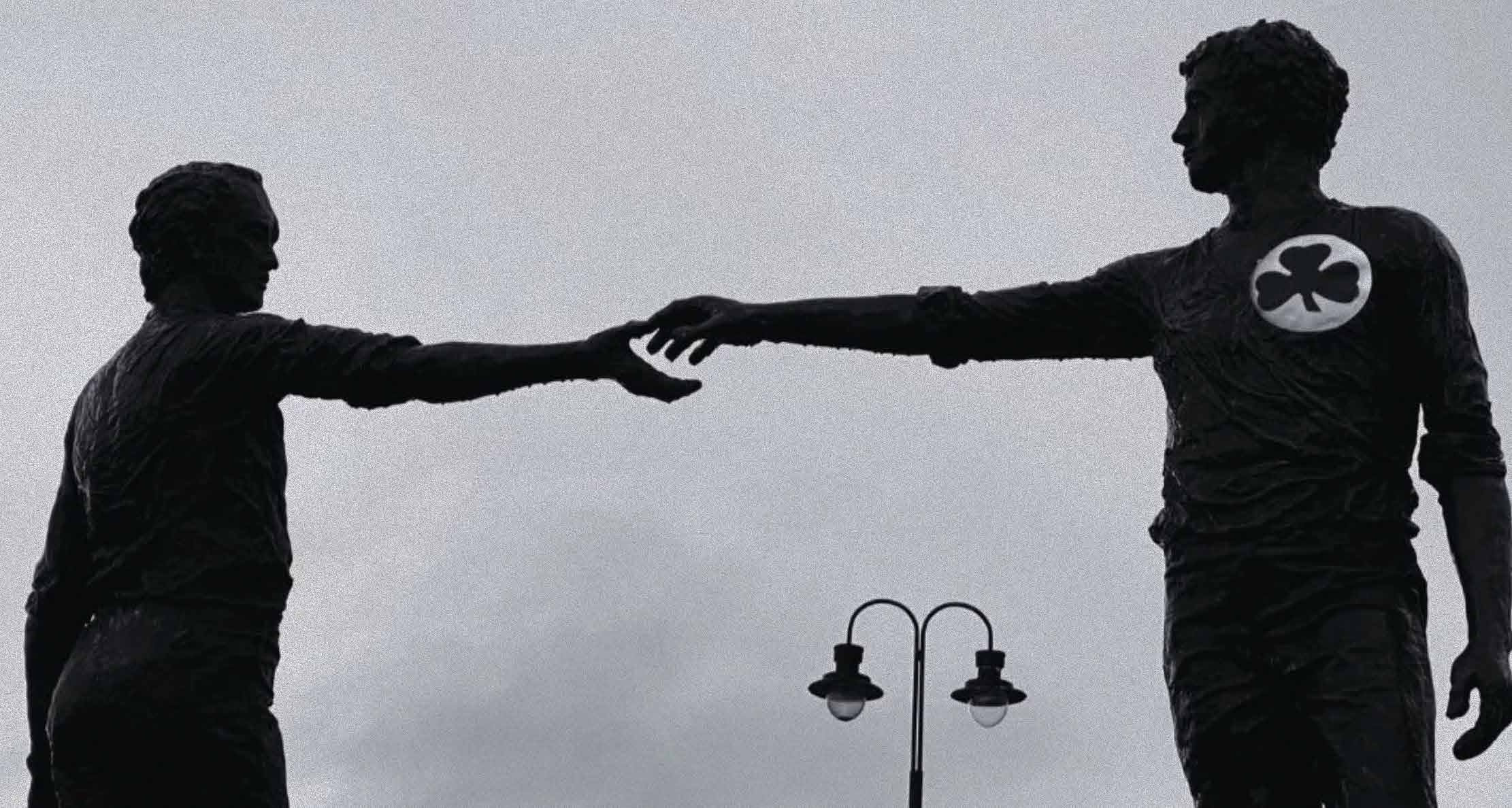 The Hands Across the Divide sculpture in Derry, one figure bearing the Black Shamrock